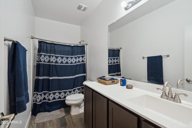 1135 E Barrus Dr, Casa Grande, AZ 85122 - bathroom featuring toilet, visible vents, vanity, and wood finished floors
