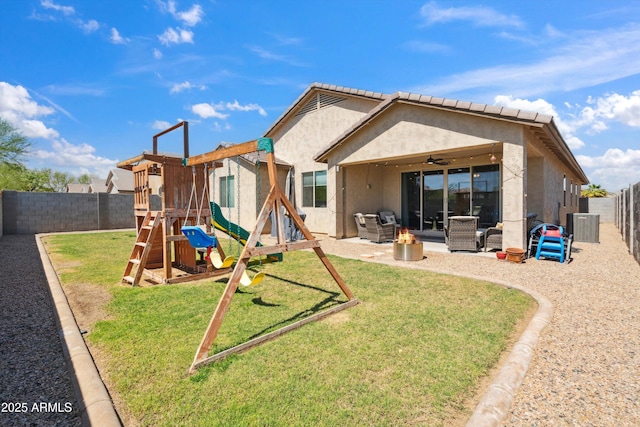 1135 E Barrus Dr, Casa Grande, AZ 85122 - back of house with a fenced backyard, a yard, stucco siding, and a playground