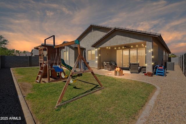 1135 E Barrus Dr, Casa Grande, AZ 85122 - back of house featuring a fenced backyard, a playground, a yard, and a patio