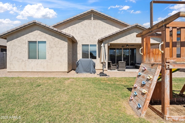 1135 E Barrus Dr, Casa Grande, AZ 85122 - rear view of house featuring a ceiling fan, stucco siding, fence, a patio, and a lawn