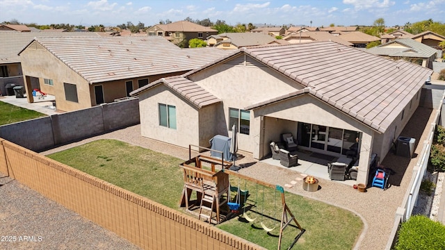 1135 E Barrus Dr, Casa Grande, AZ 85122 - rear view of house featuring a fenced backyard, stucco siding, a patio, and a playground