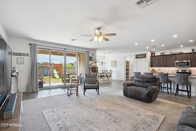 1135 E Barrus Dr, Casa Grande, AZ 85122 - living area featuring ceiling fan with notable chandelier, visible vents, baseboards, and recessed lighting
