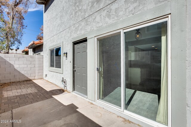 entrance to property featuring a patio