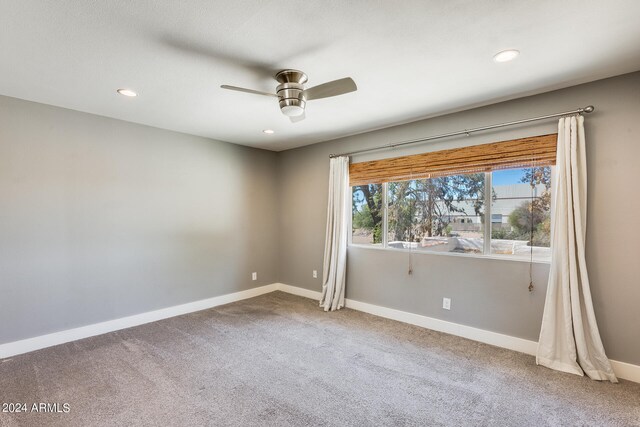 spare room with carpet floors and ceiling fan