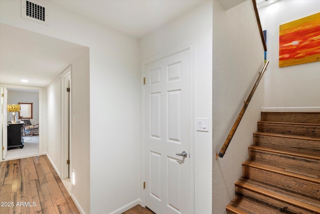 stairs featuring wood-type flooring