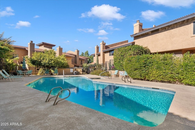 view of swimming pool with a patio