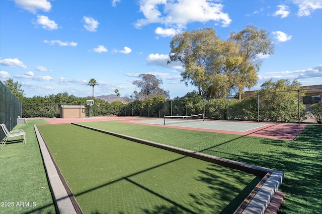 view of sport court featuring a mountain view and basketball hoop