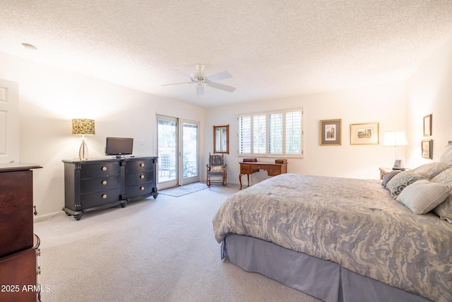 bedroom with ceiling fan, light colored carpet, access to exterior, and a textured ceiling