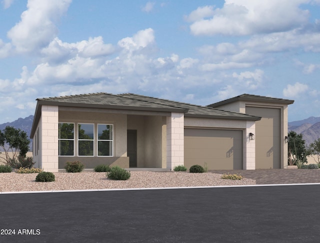 view of front facade featuring a garage and a mountain view