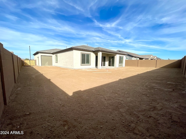 rear view of property featuring a garage