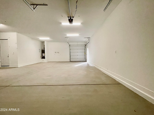 garage featuring a garage door opener and water heater