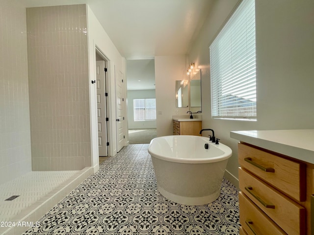 bathroom featuring tile patterned floors, vanity, and separate shower and tub