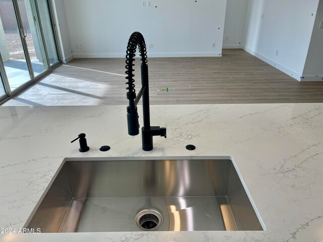 room details featuring sink and light hardwood / wood-style floors