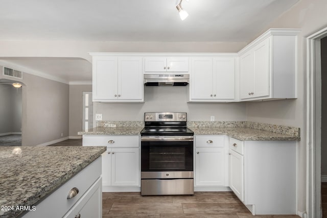 kitchen featuring white cabinets, electric range, and light stone counters