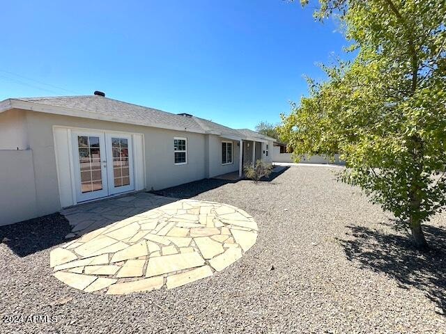 rear view of property with french doors and a patio area