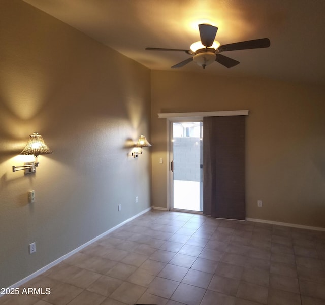 tiled empty room featuring ceiling fan