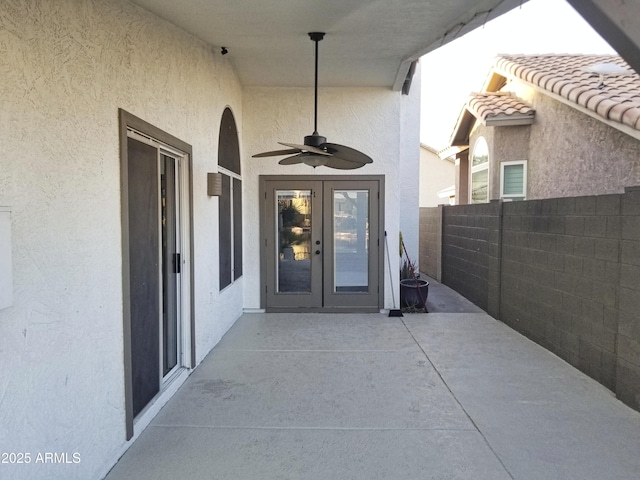 property entrance with a patio, french doors, and ceiling fan