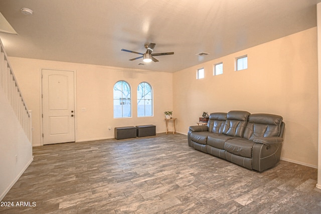 living room with dark hardwood / wood-style floors and ceiling fan