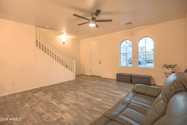 unfurnished living room featuring dark hardwood / wood-style floors and ceiling fan