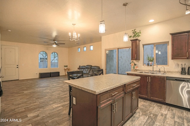 kitchen with sink, a center island, decorative light fixtures, stainless steel dishwasher, and dark hardwood / wood-style flooring