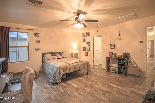 bedroom with wood-type flooring and ceiling fan