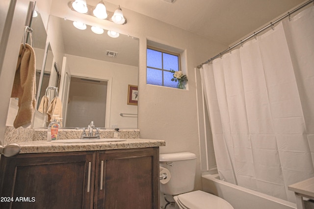 full bathroom with vanity, shower / tub combo, and toilet