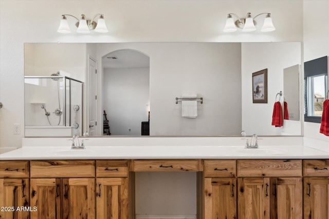 bathroom featuring walk in shower and vanity