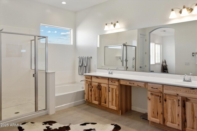 bathroom featuring separate shower and tub and vanity