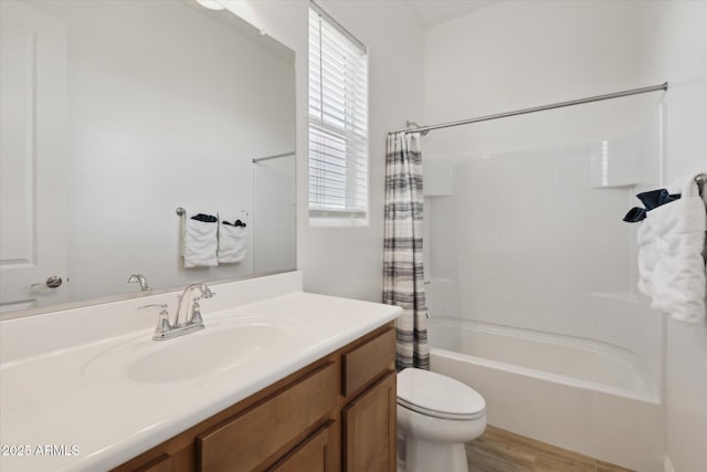 full bathroom featuring toilet, shower / bath combination with curtain, hardwood / wood-style flooring, and vanity