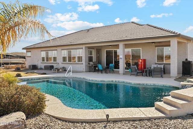 back of house featuring ceiling fan, a patio area, cooling unit, and an outdoor hangout area