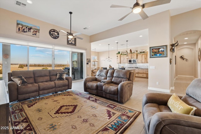 tiled living room featuring ceiling fan