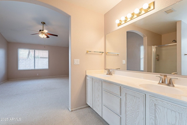 full bathroom with an enclosed shower, visible vents, a ceiling fan, and a sink