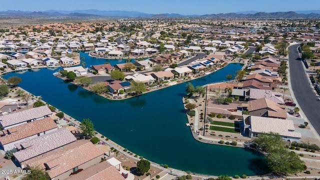 drone / aerial view with a residential view and a water and mountain view