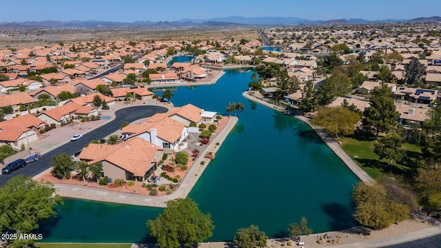 drone / aerial view featuring a residential view and a water and mountain view