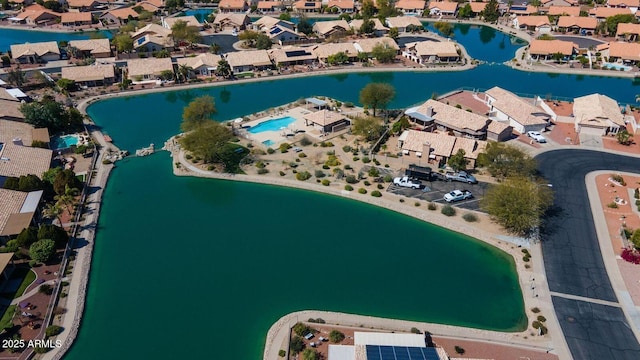 drone / aerial view featuring a residential view and a water view