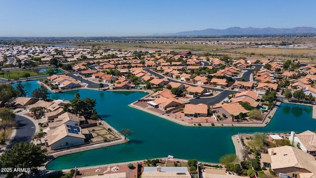 drone / aerial view featuring a residential view and a water and mountain view