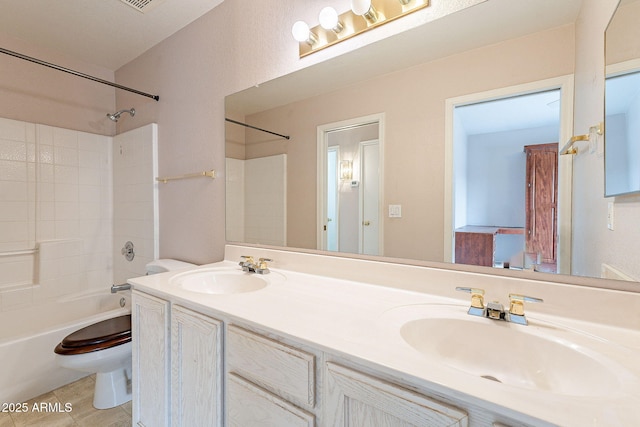 full bathroom with tile patterned flooring, shower / washtub combination, toilet, and a sink