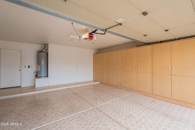 garage featuring gas water heater, a garage door opener, and baseboards