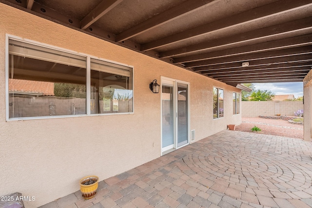 view of patio featuring fence and visible vents