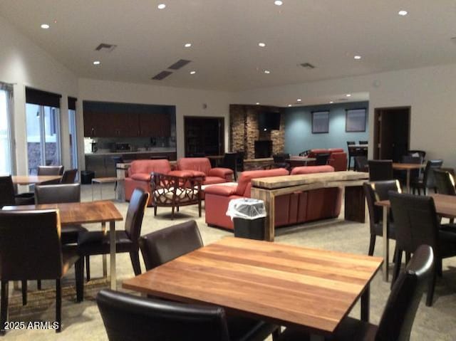 dining space featuring recessed lighting, visible vents, and a fireplace