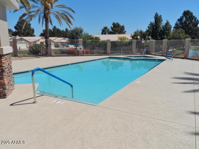 pool featuring a patio area and fence