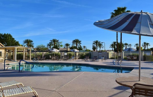 pool featuring a patio and fence