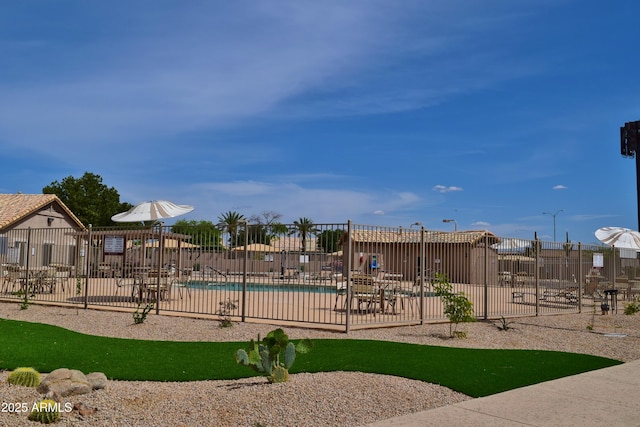 view of play area with a patio area, a community pool, and fence