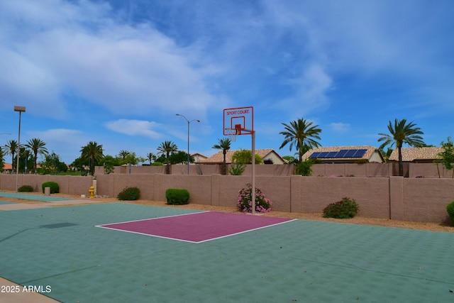 view of sport court featuring basketball court and fence