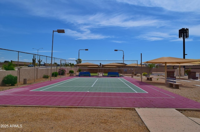 view of sport court featuring fence