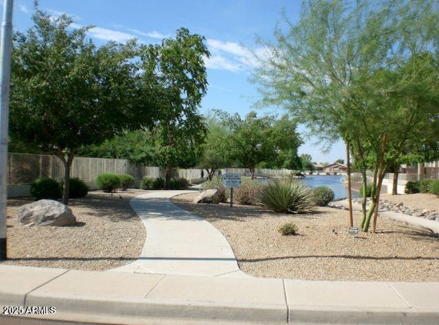 view of yard featuring a water view and fence