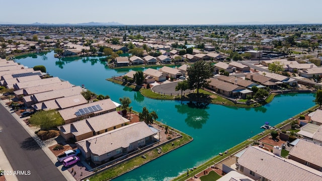 drone / aerial view featuring a residential view and a water view