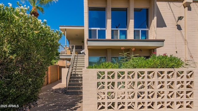 view of front facade with fence and stairway