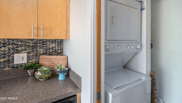 washroom featuring laundry area and stacked washer / drying machine