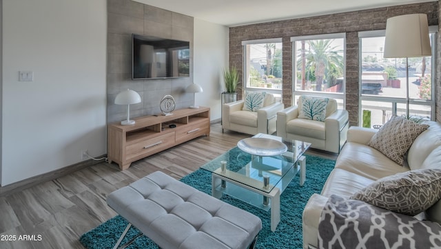 living area with light wood-style flooring and baseboards